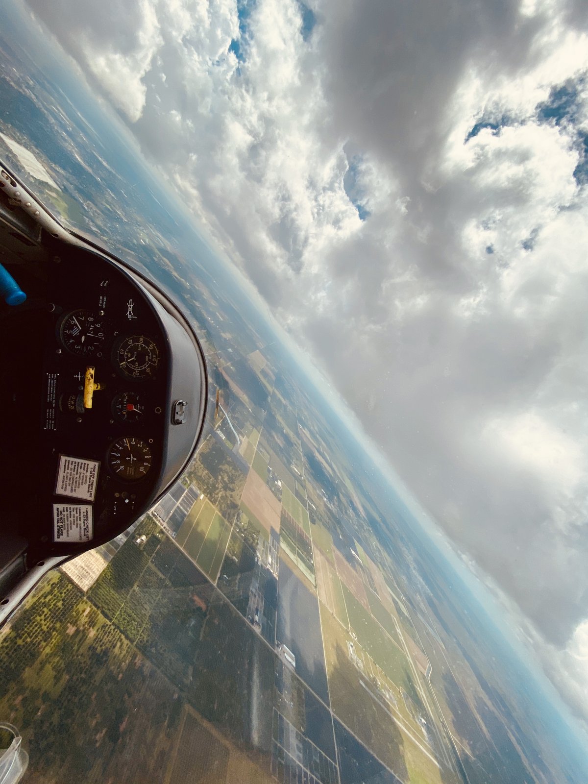 Cockpit view banking steeply over the South Florida fields
